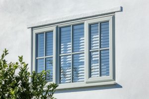 window-with-white-frame-and-shut-blinds